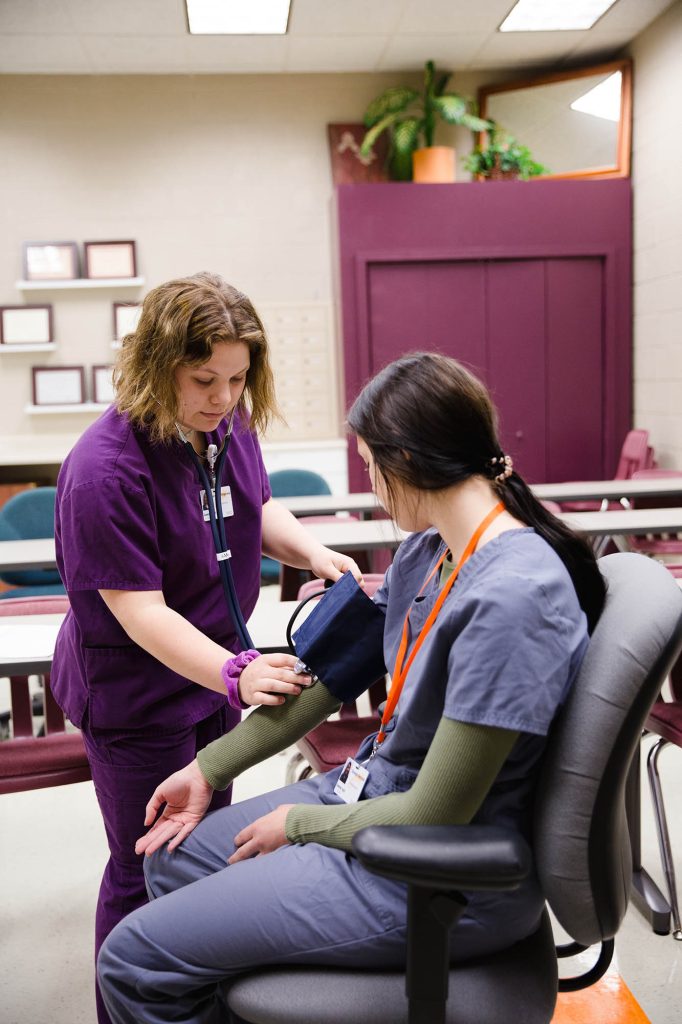 Central Tech student practicing taking someones blood pressure