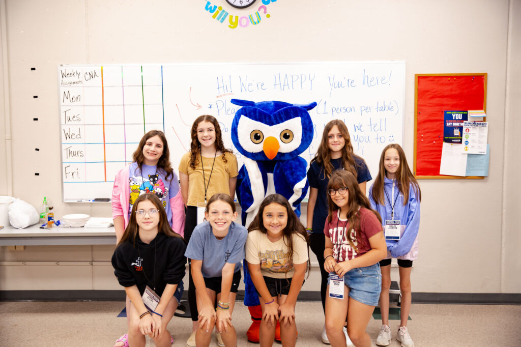 Explorers camp kids posing with the Central Tech owl mascot