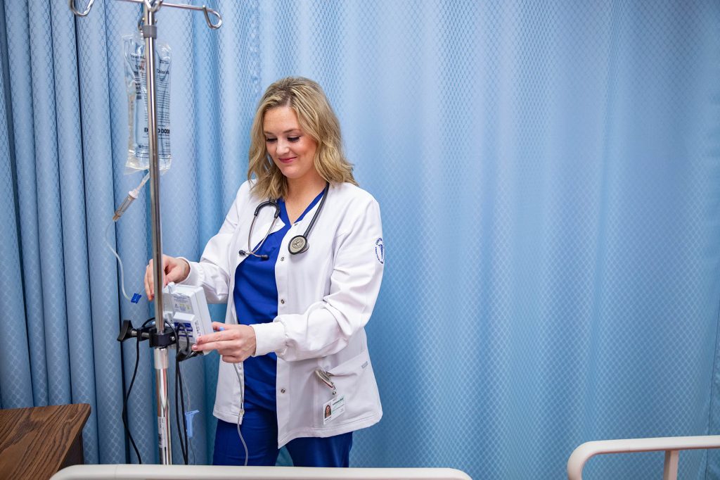 PN student checking an IV at Central Tech