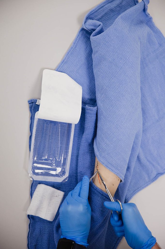 PN student learning how to do sutures at Central Tech