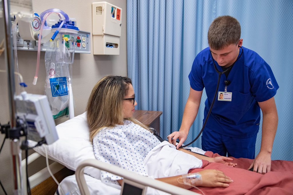 Practical Nursing student checking on a patient