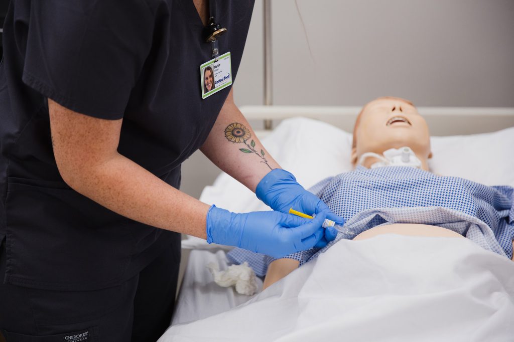 nursing student practicing giving an injection at Central Tech