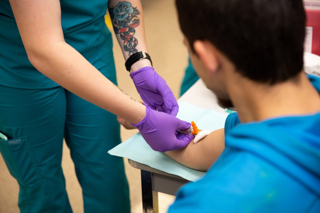 phlebotomy student taking blood