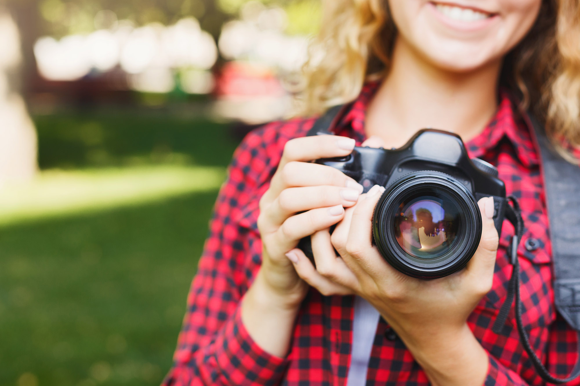 photo of a woman holding a camera