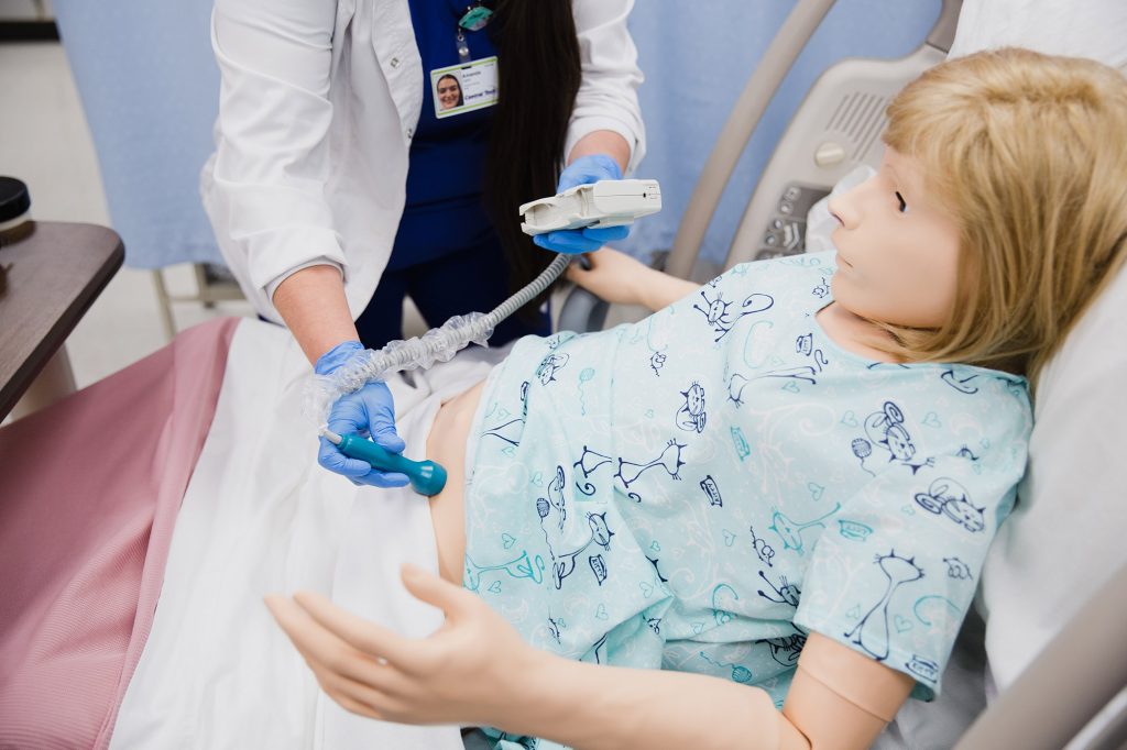 student checking an OB patient and baby heartbeat
