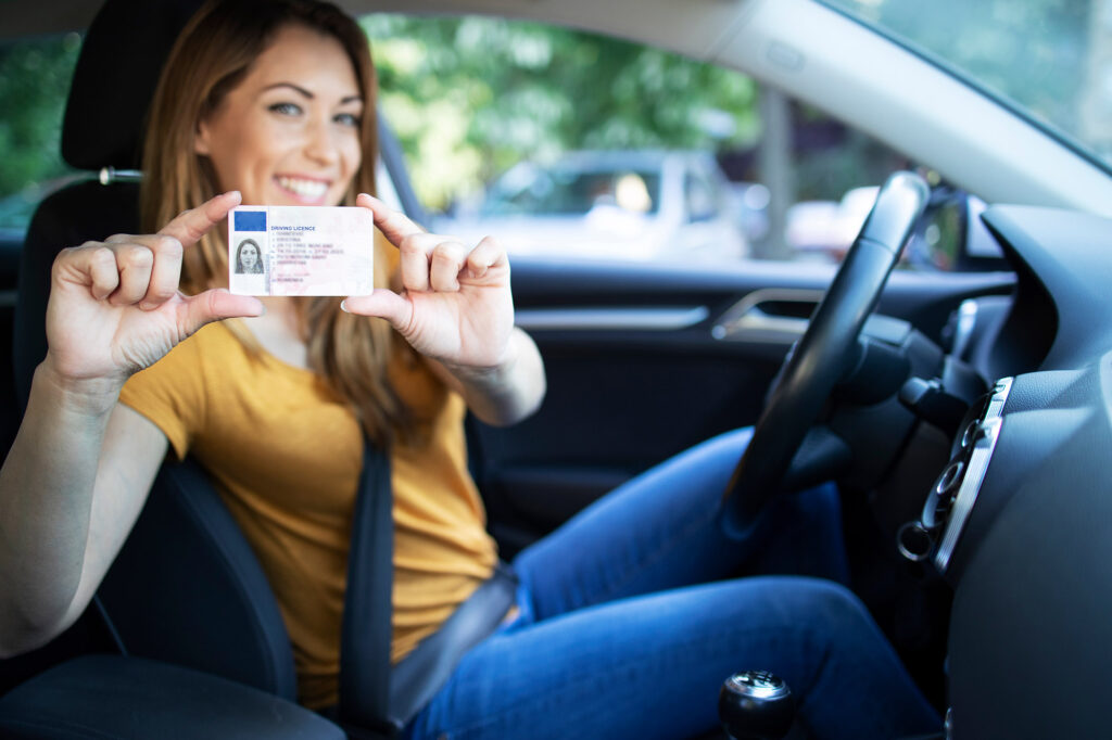 woman holding drivers license